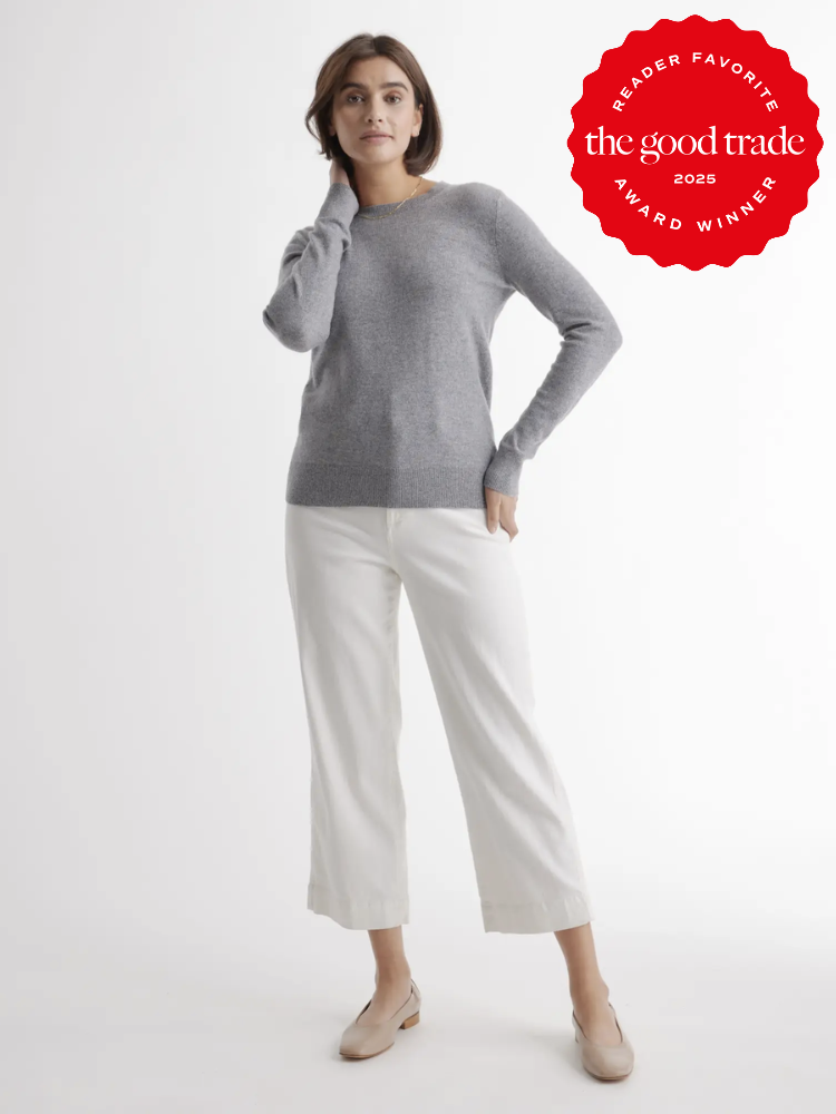 Person wearing a gray sweater and white pants stands against a plain background. A red badge on the top right reads "Reader Favorite the good trade 2025 Award Winner.